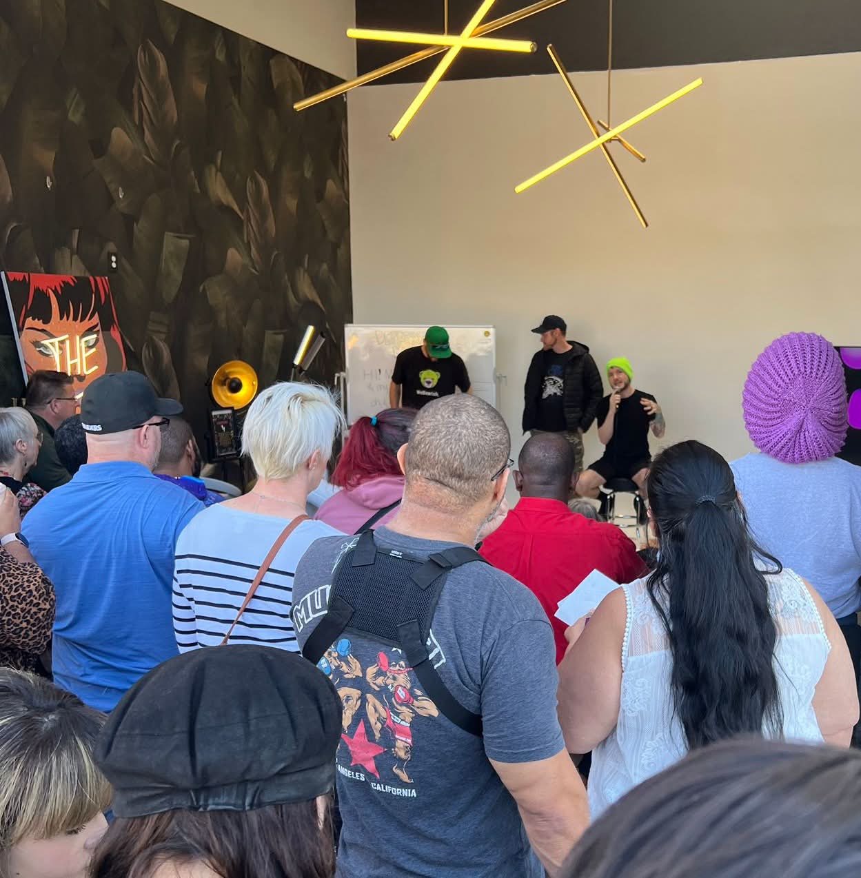 Cash on stage at an autism community event with an audience in front.